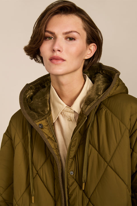Oversized long puffer coat with diamond quilting, corduroy trim, hood, welt pockets, and Ecoplume insulation.