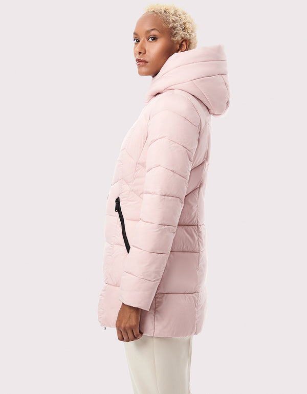 side view of coral quilted puffer outerwear with attached plush hood made from eco green materials
