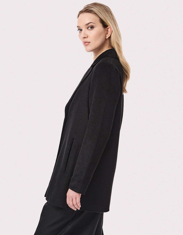 side view of an oversized layerable black wool coat that is classy and comfortable fit design
