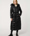 Woman wearing a long black puffer coat with a fur-lined hood on a white background