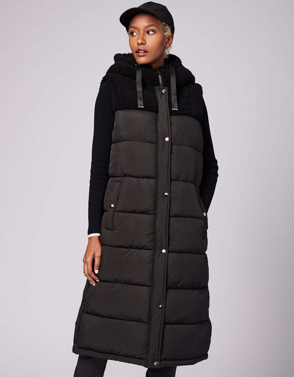 buy this long puffer vest for late fall and winter for women shopping sustainable styles made with recycled materials and street style appeal