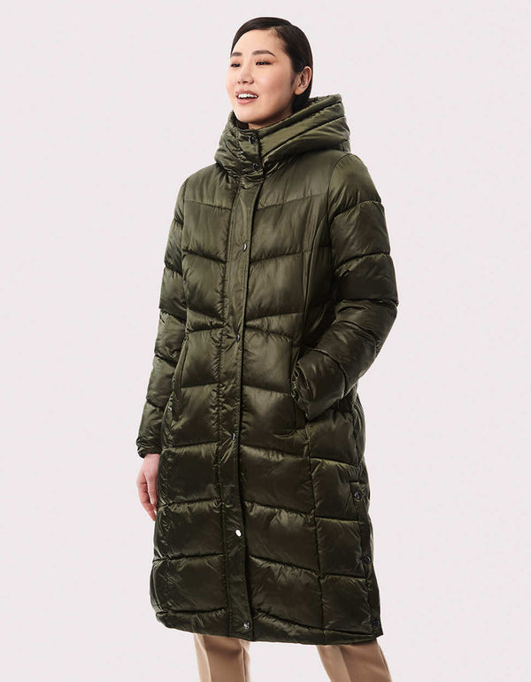 sustainable outerwear options for women during winter in a green long puffer coat semi fitted mid length fit