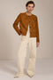 Collarless genuine suede jacket with oversized patch pockets, button-front closure and tailored silhouette.