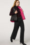 Women's black and pink reversible puffer vest for breast cancer awareness month. Lightweight for effortless layering.