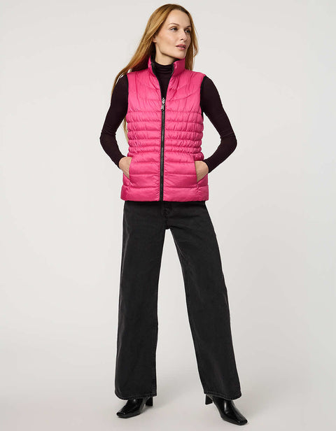 Women's black and pink reversible puffer vest for breast cancer awareness month. Lightweight for effortless layering.