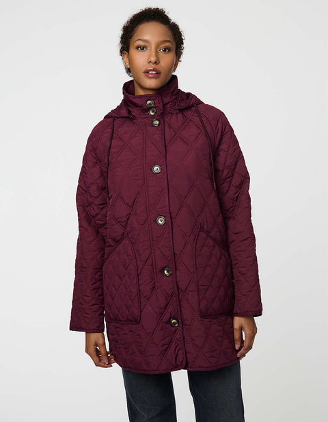 Lightweight quilted puffer jacket for women. The perfect spring layer with drawstring hood and oversized pockets,