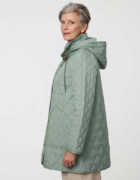 Lightweight quilted puffer jacket for women. The perfect spring layer with drawstring hood and oversized pockets,