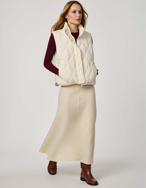 Women’s quilted puffer vest with oversized fit, funnel collar, zipper closure, and lightweight Ecoplume fill.