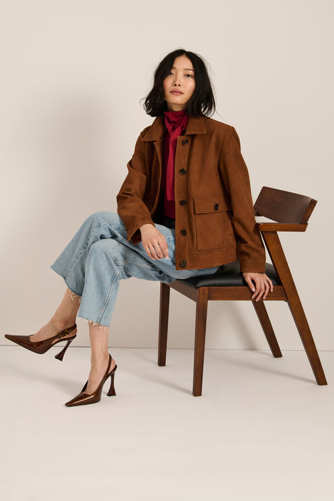 Genuine suede utility jacket with point collar, concealed button-front closure and oversized flap pockets.
