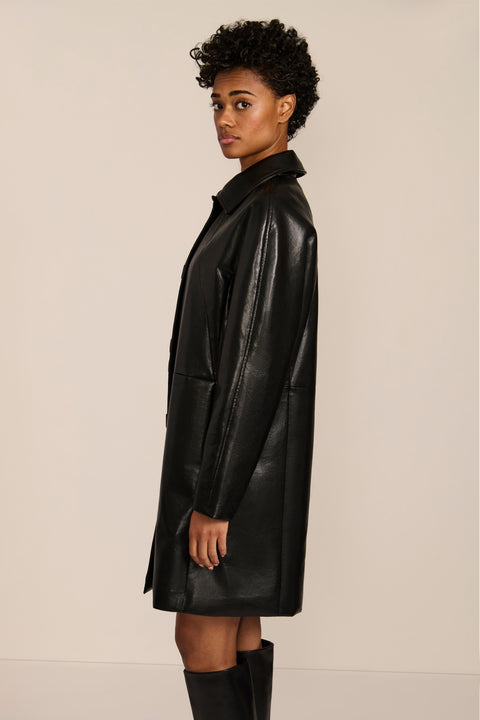 Women's black genuine leather car coat with point collar, button-front closure and side pockets.