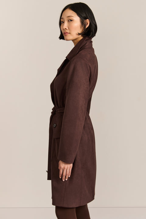 women's faux suede trench coat with a double-breasted front, notched lapels, belted waist and buckle cuff details.