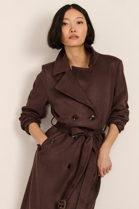 women's faux suede trench coat with a double-breasted front, notched lapels, belted waist and buckle cuff details.