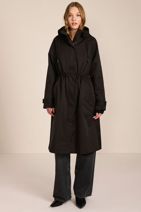 Women's water-repellent hooded raincoat with adjustable drawcord waist and patch pockets