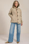 Women's barn raincoat with corduroy collar, plaid lining, and water-repellent finish.