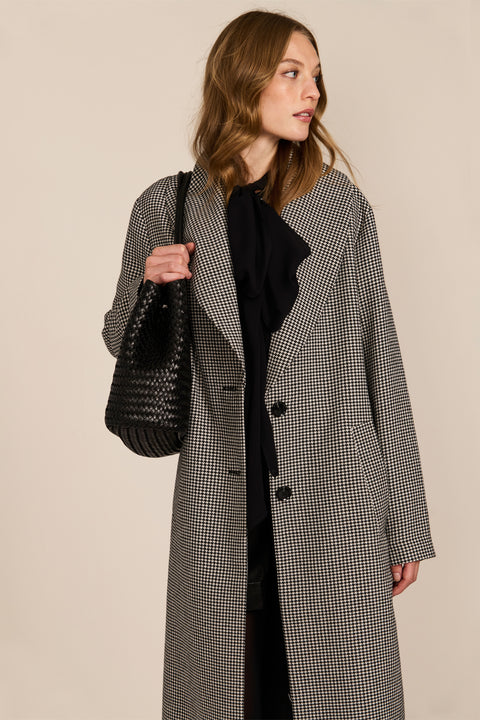 Women's brown houndstooth long coat with oversized notched collar, two-button closure and welt pockets.