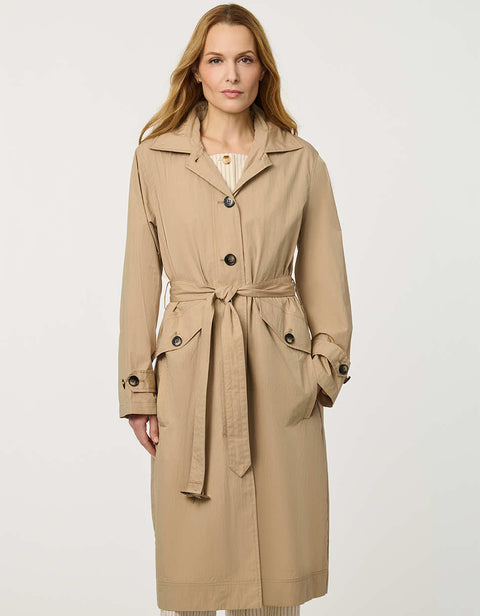 Women’s lightweight utility trench coat with belted waist, flap pockets, and roll-away hood tucked into the collar.