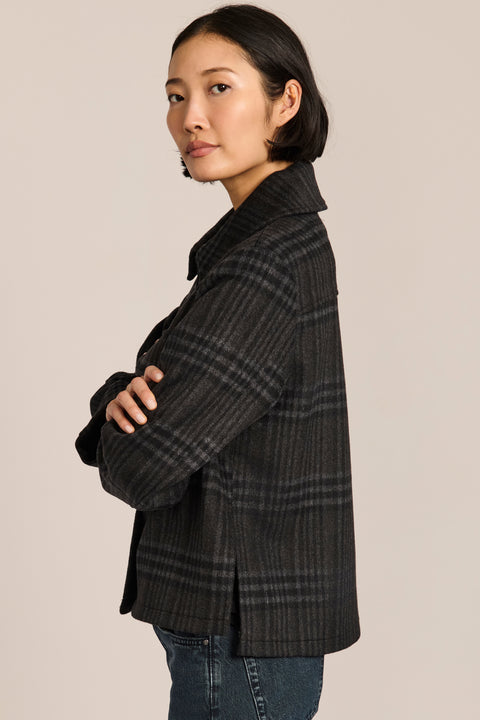 women's cropped plaid wool jacket featuring a point collar, button-front closure, and oversized flap pockets.