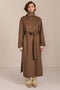 Women's long belted wool coat featuring a high stand collar, asymmetric button closure, wide cuffs and side slits.