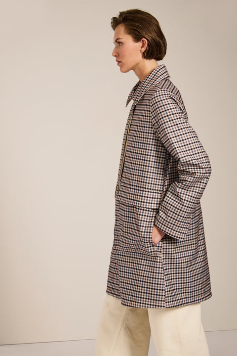 Women's check print raincoat with utility pockets, corduroy collar, and water-repellent finish