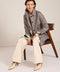 Women's check print raincoat with utility pockets, corduroy collar, and water-repellent finish