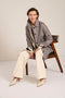 Women's check print raincoat with utility pockets, corduroy collar, and water-repellent finish