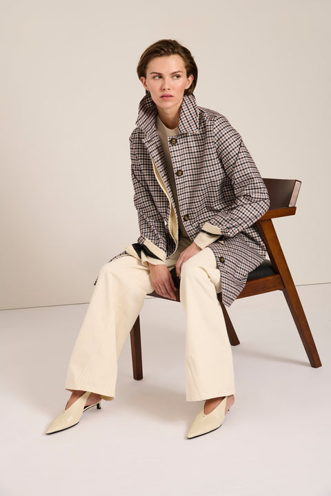 Women's check print raincoat with utility pockets, corduroy collar, and water-repellent finish