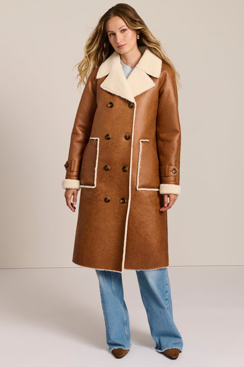 women's faux shearling coat featuring ivory contrast trim, an oversized notched collar, double-breasted button closure and patch pockets.