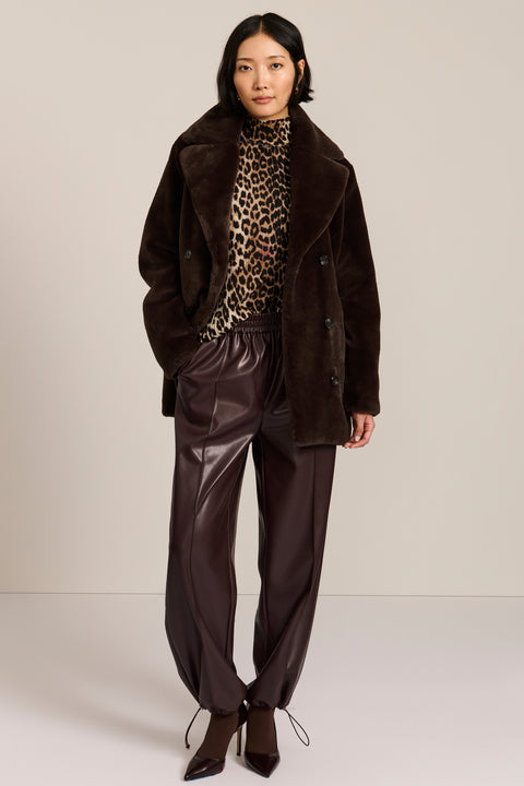 women's dark brown double-breasted faux fur coat with an oversized notched collar, button front, and angled pockets.