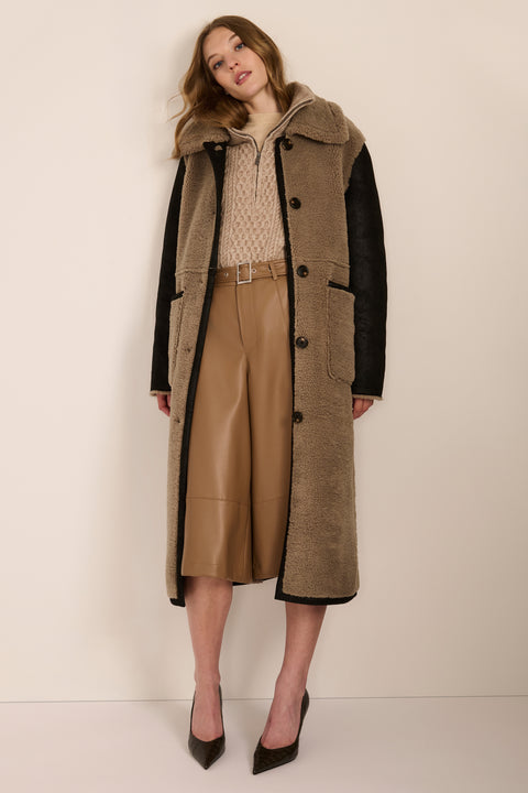 women's Mixed Media Faux Shearling Coat in taupe with black faux leather contrast sleeves, oversized collar and longline silhouette.