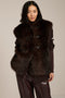 Women's faux fur vest with toggle closures, stand collar, and side pockets.