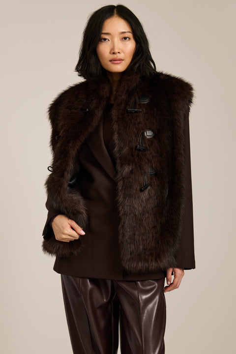 Women's faux fur vest with toggle closures, stand collar, and side pockets.