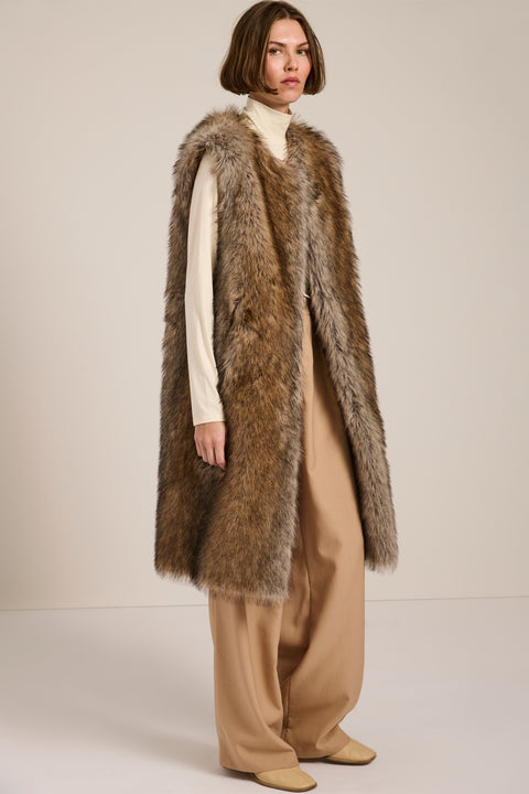 A model in a women's long faux fur vest.
