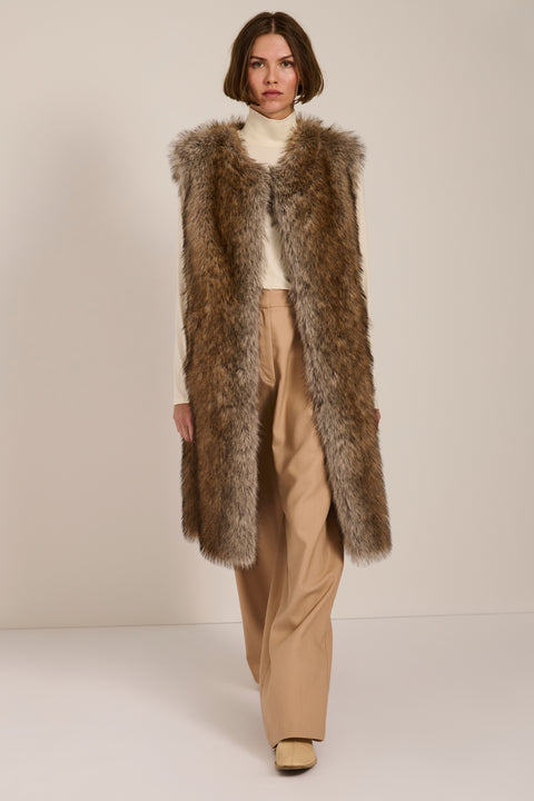 A long faux fur vest with a collarless neckline worn by a New York woman.
