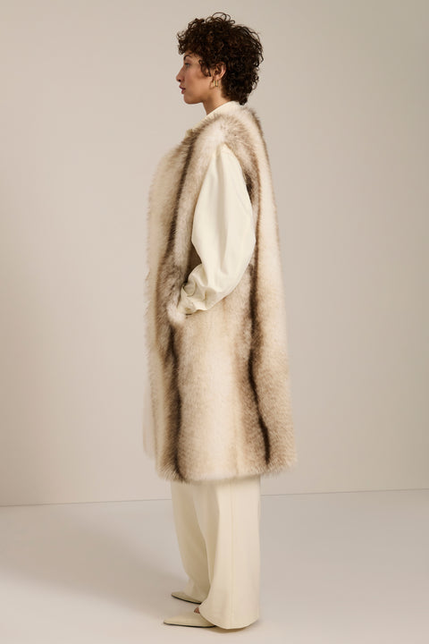 The profile of a woman in one of Bernardo's long faux fur vests.
