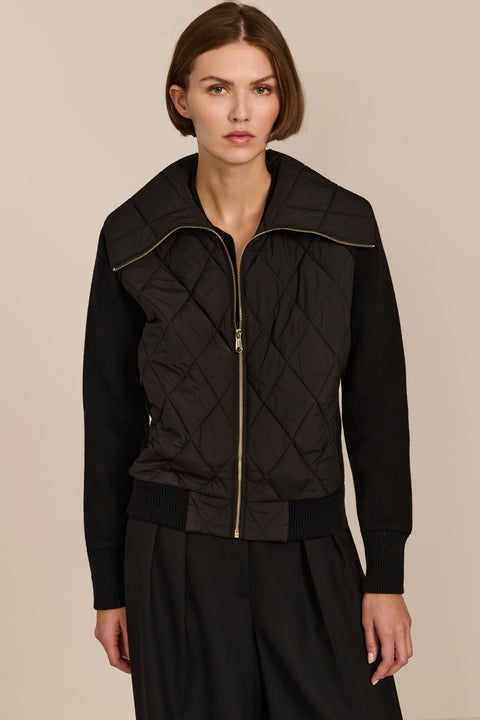Women's quilted bomber jacket with knit sleeves.