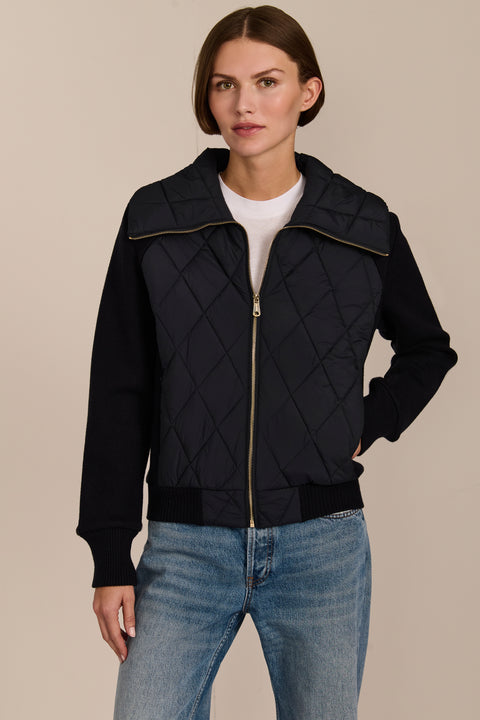 Women's quilted bomber jacket with knit sleeves.