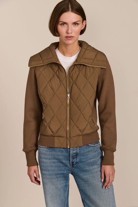 Women's quilted bomber jacket with knit sleeves.