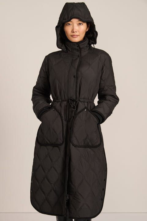 women's Long Quilted Puffer Coat with drawstring waist, hood, diamond quilting and longline silhouette.