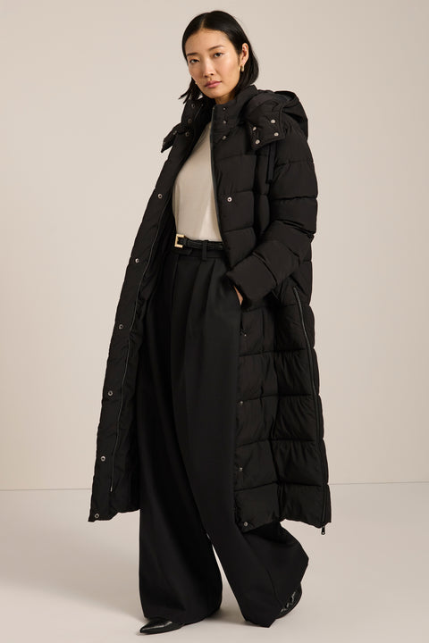Long insulated puffer coat with removable hood, hidden placket, side zip vents and zippered pockets.