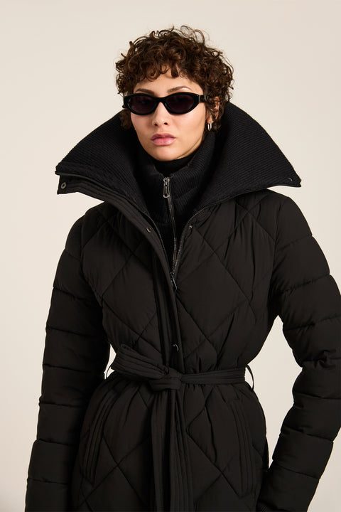 Belted quilted puffer coat with oversized diamond quilting, removable knit bib and stand collar.