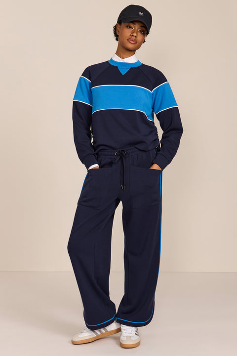 Women's navy and blue colorblock soft scuba sweatshirt with contrast piping and crew neckline.