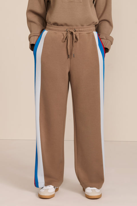 Women's soft scuba wide-leg pants with blue, white and red colorblocked side stripes and drawstring waist.
