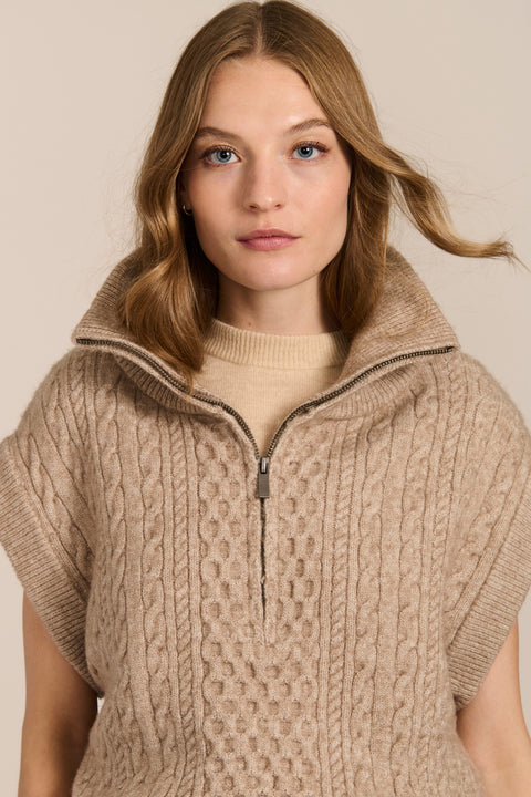 women's cable knit quarter-zip sweater vest with ribbed funnel collar, textured cable stitching and relaxed cap sleeves.