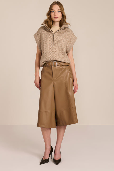 women's cable knit quarter-zip sweater vest with ribbed funnel collar, textured cable stitching and relaxed cap sleeves.