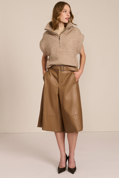 women's cable knit quarter-zip sweater vest with ribbed funnel collar, textured cable stitching and relaxed cap sleeves.