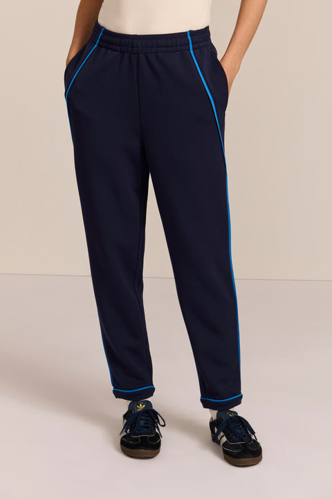 Women's navy soft scuba pull-on pants with blue contrast piping, elastic waistband and tapered leg.