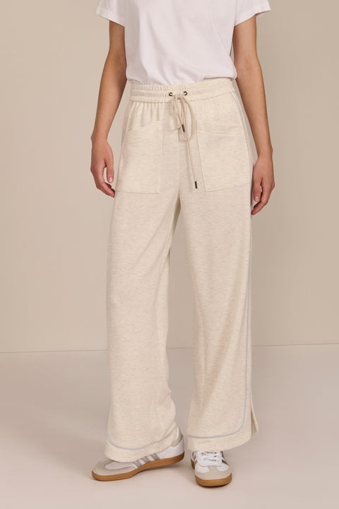 Women's soft scuba wide-leg pants with light blue piping, patch pockets, drawstring waist and side slits.
