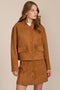 women's camel faux suede bomber jacket with a tonal snap front and flap pockets, styled with the coordinating mini skirt.
