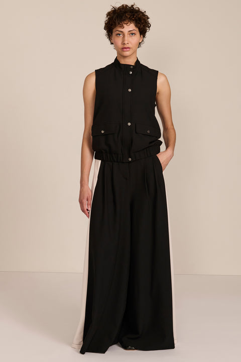 women's black sleeveless utility bomber vest featuring a stand collar, snap-front closure, flap pockets and elasticized hem.