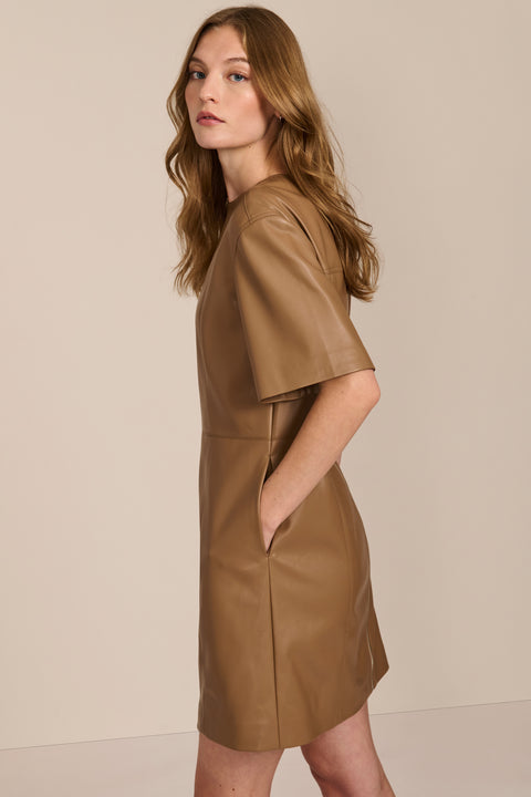 women's camel faux leather shift dress featuring short sleeves, a crew neckline, seam detailing and side pockets.